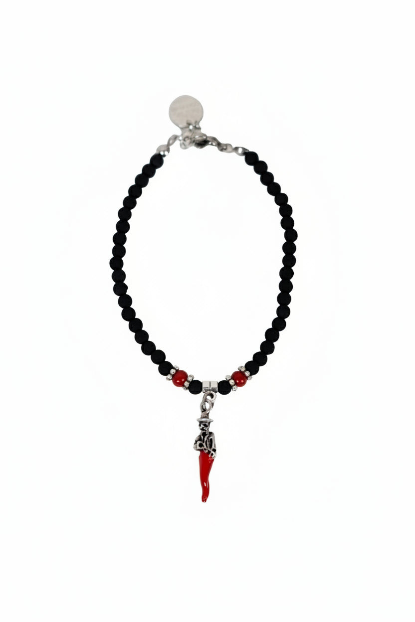 Bracciale con perline nere e ciondolo scartellato in metallo con corno rosso portafortuna napoletano su sfondo bianco