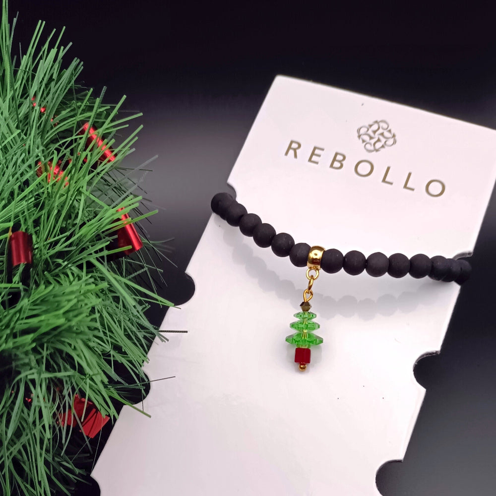 Bracciale in pietra lavica sintetizzata con ciondolo albero di Natale in vetro di Murano su card con logo Rebollo